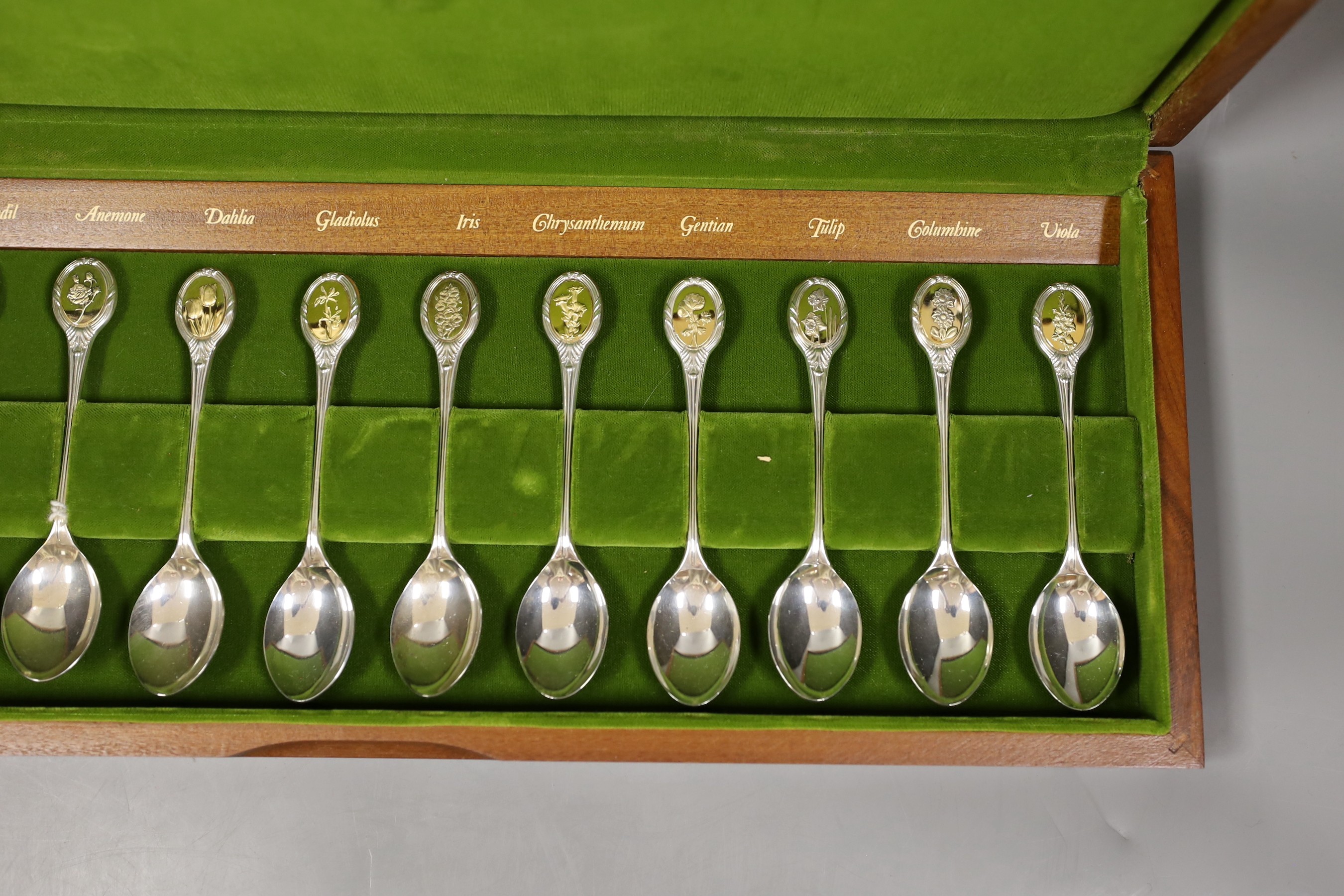 A cased set of twelve commemorative Royal Horticultural Society flower spoons, with silver gilt finials, gross 10oz